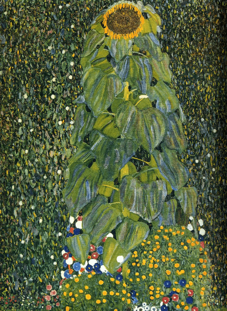 A vibrant sunflower towering over lush green leaves, surrounded by colorful flowers in a garden setting.